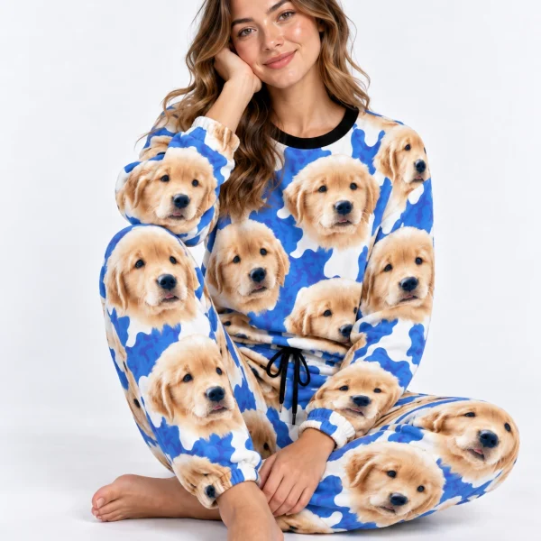 Woman sitting in warm pajamas covered in golden retriever puppy faces — MyDogPics