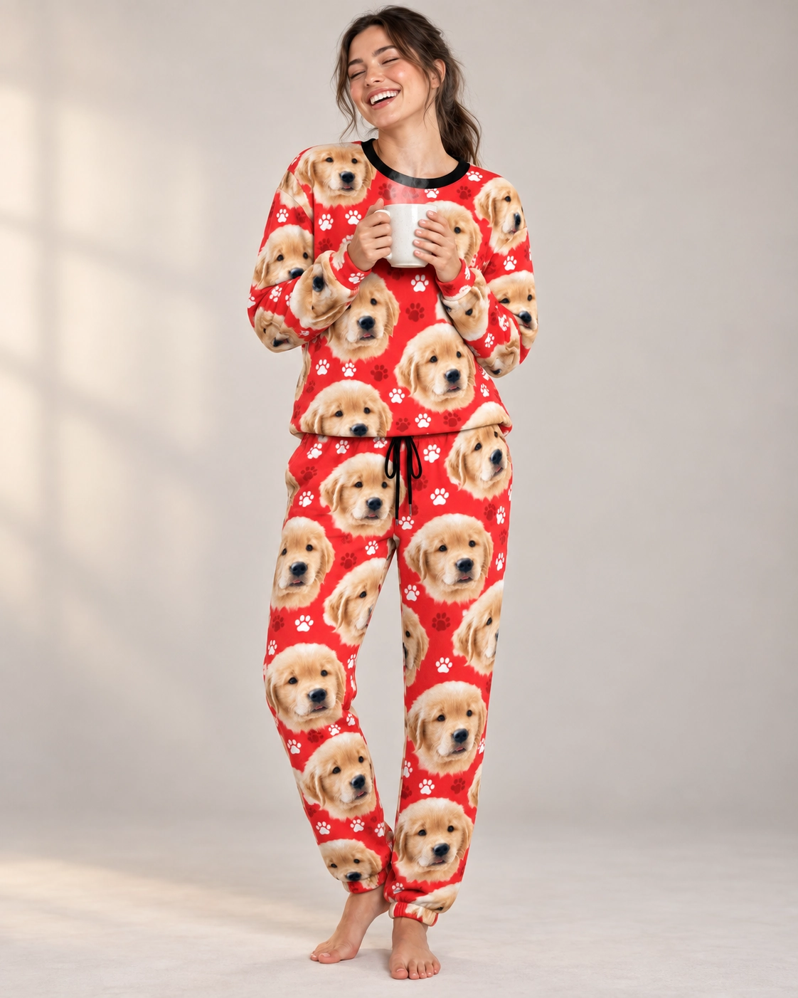 Women’s Christmas Pajamas – Front View, Red Paw-Print | MyDogPics Woman wearing womens Christmas pajamas covered in golden retriever puppy faces on red paw-print fabric — MyDogPics
