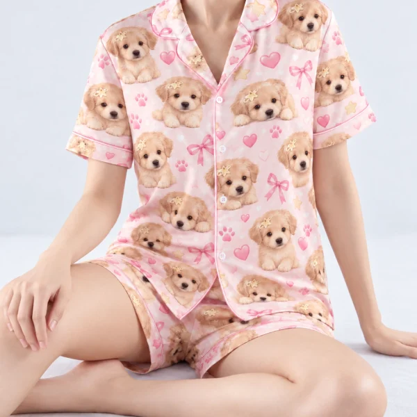 Woman sitting in womens dog pajamas covered in fluffy cream puppy faces — MyDogPics