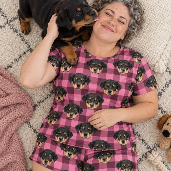 Woman in womens sleepwear cuddling her Rottweiler puppy — MyDogPics