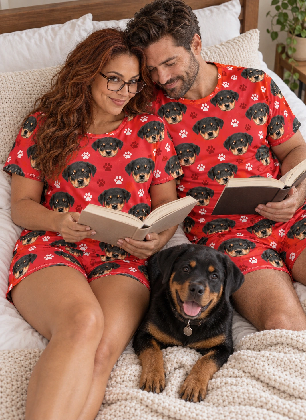 Women’s Sleepwear – Family, Red Paw-Print | MyDogPics Woman and her partner in matching womens sleepwear with Rottweiler puppy faces on red paw-print fabric — MyDogPics