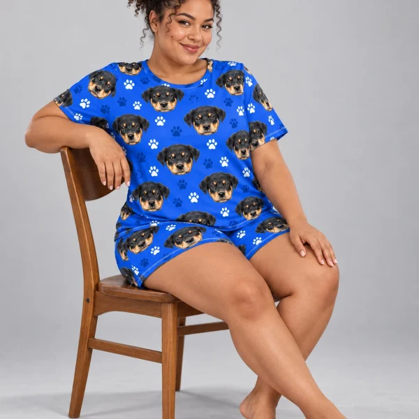 Woman sitting in womens sleepwear covered in Rottweiler puppy faces — MyDogPics