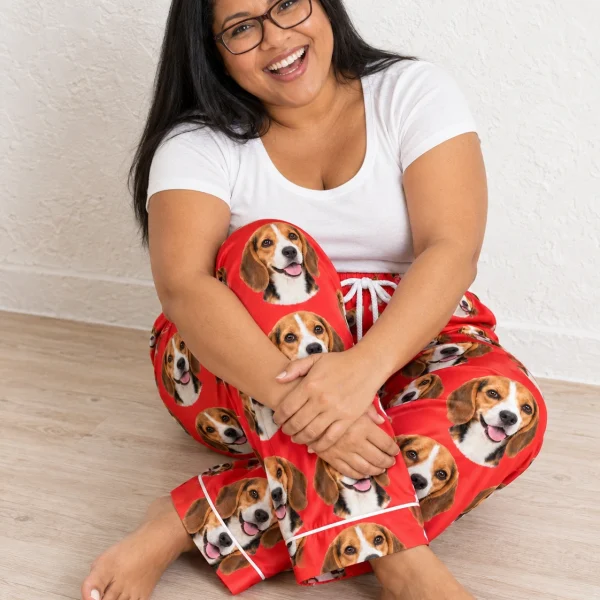 Woman sitting in beagle Valentine pajamas covered in tricolor Beagle (black, tan and white) faces — MyDogPics