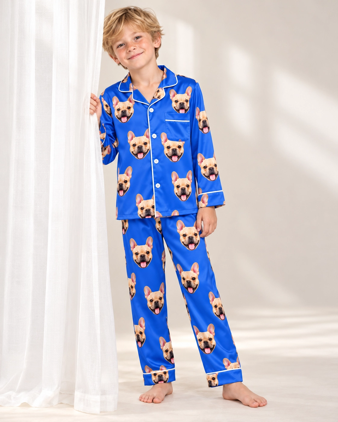 Big Boys Pajamas – Front View, Royal Blue | MyDogPics Boy wearing big boys pajamas covered in fawn French bulldog faces on royal blue satin — MyDogPics