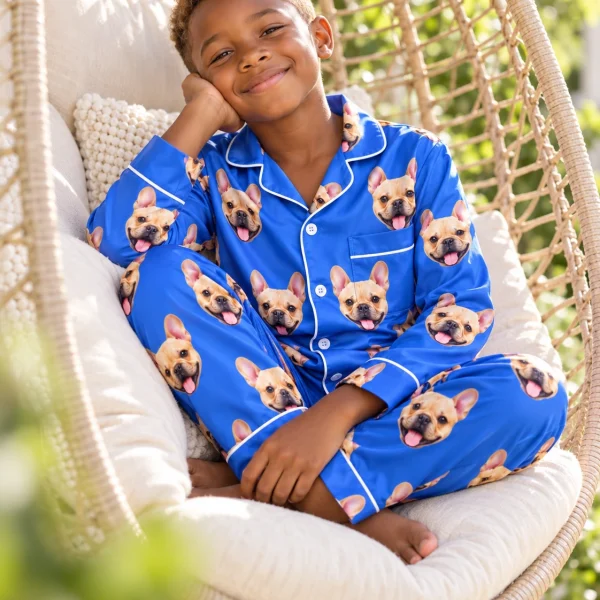 Boy sitting in big boys pajamas covered in fawn French bulldog faces — MyDogPics