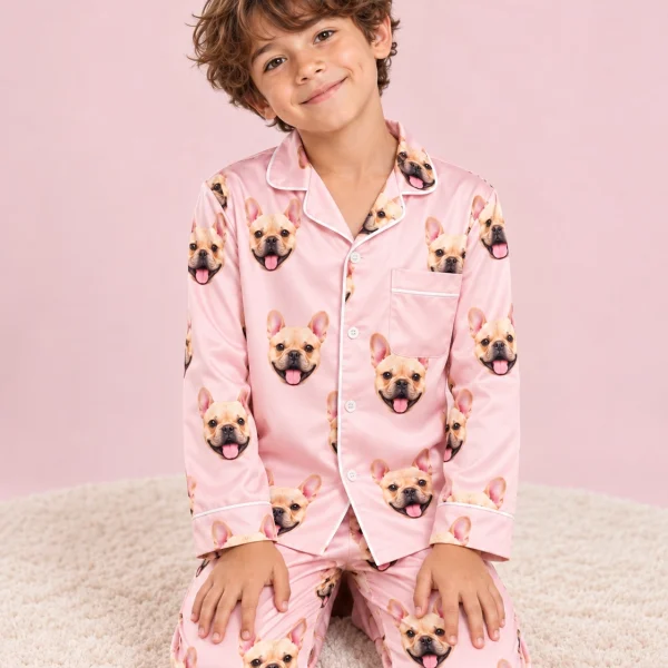 Boy posing in boys easter pajamas, fawn French bulldog faces on blush pink satin — MyDogPics