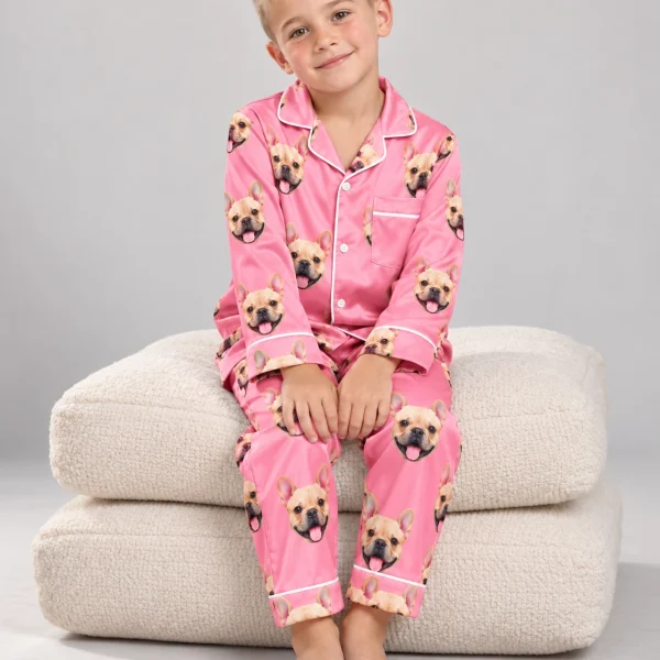 Boy sitting in boys Valentines pajamas covered in fawn French bulldog faces — MyDogPics