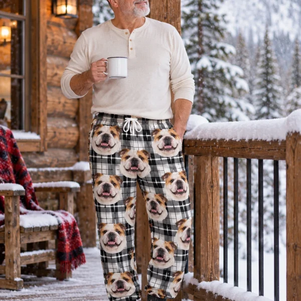 Man posing in bulldog pajama pants, white-and-fawn English Bulldog faces on white plaid fabric — MyDogPics