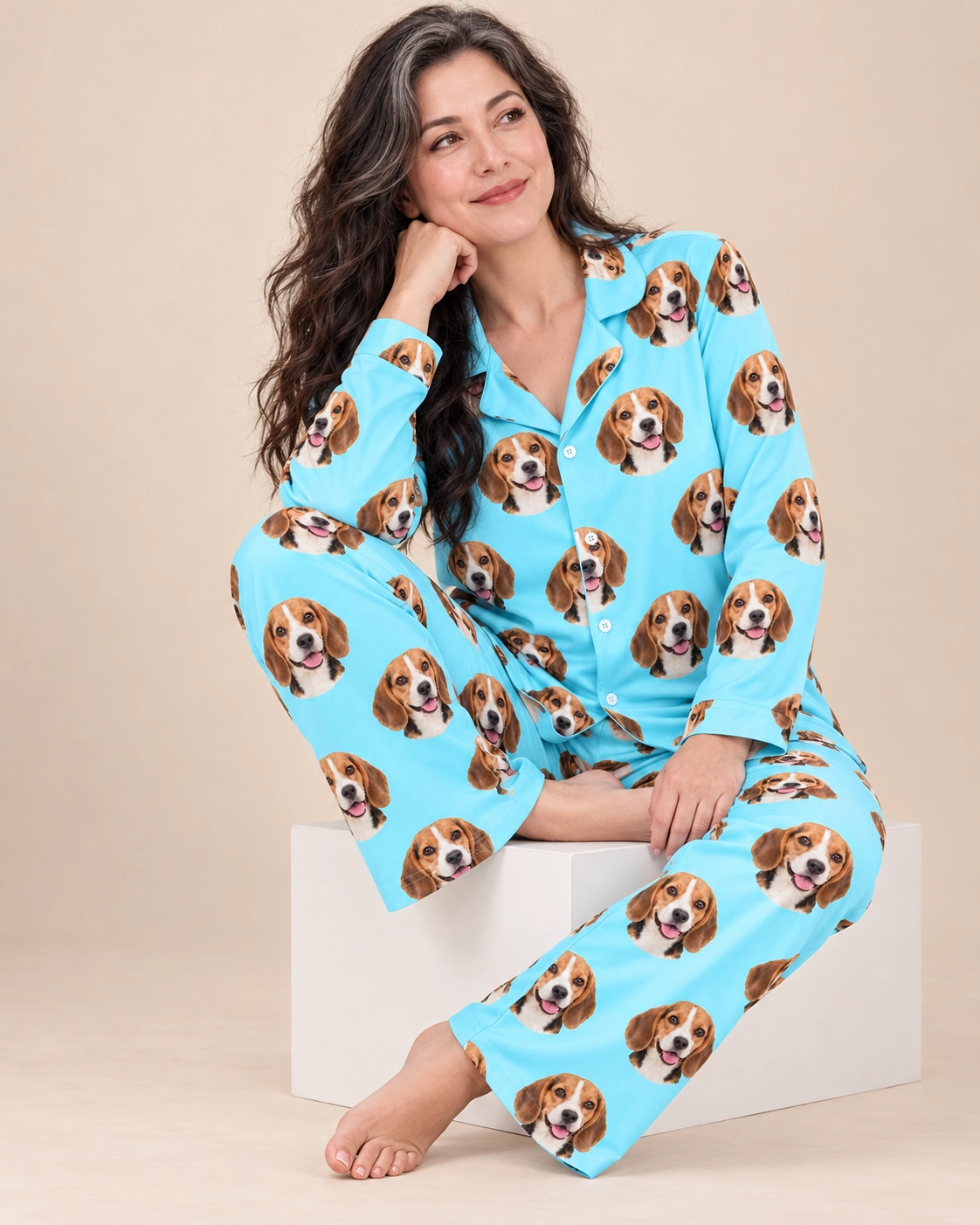 Custom Beagle Pajamas – Sitting, Light Blue | MyDogPics Woman sitting in custom beagle pajamas covered in tricolor Beagle (black, tan and white) faces — MyDogPics