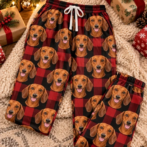 Flat lay of dachshund Christmas pants: pants covered in red smooth-coated Dachshund faces — MyDogPics
