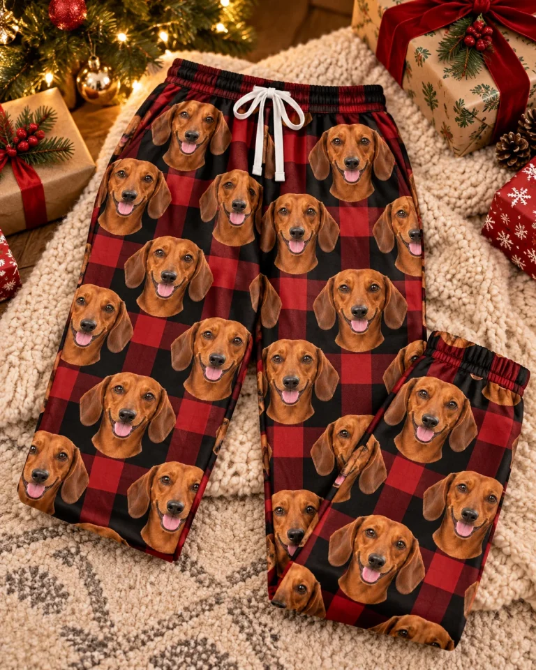 Flat lay of dachshund Christmas pants: pants covered in red smooth-coated Dachshund faces — MyDogPics