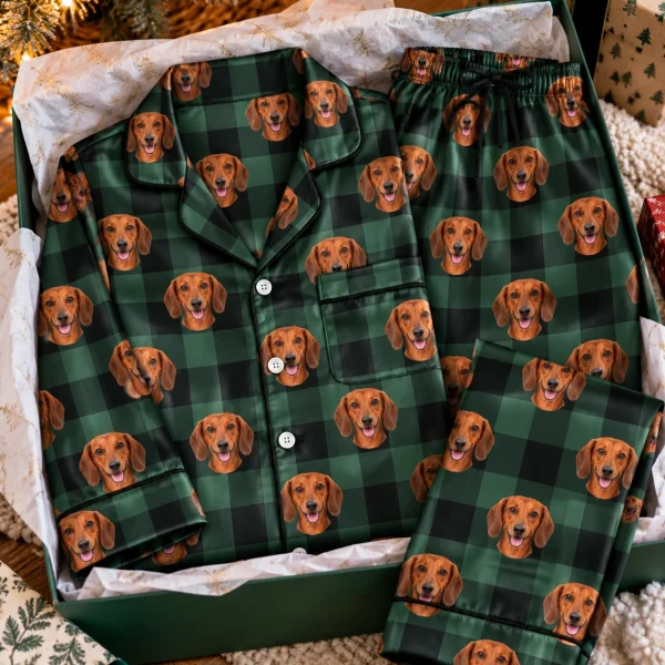 Flat lay of dachshund holiday pajamas: shirt and pants covered in red smooth-coated Dachshund faces — MyDogPics