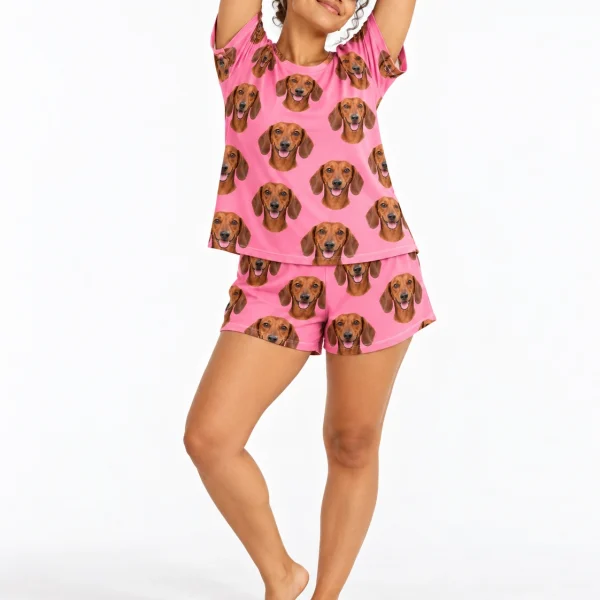 Woman posing in a dachshund lounge set, red smooth-coated Dachshund faces on pink fabric — MyDogPics