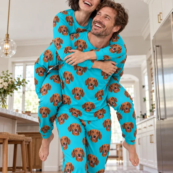 Woman and her partner in matching dachshund pajamas for adults with red smooth-coated Dachshund faces — MyDogPics