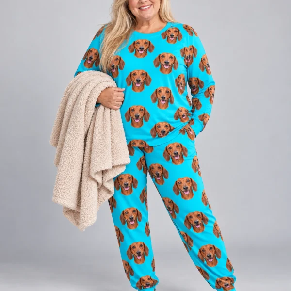 Woman wearing a dachshund pajamas for adults covered in red smooth-coated Dachshund faces on teal fabric — MyDogPics