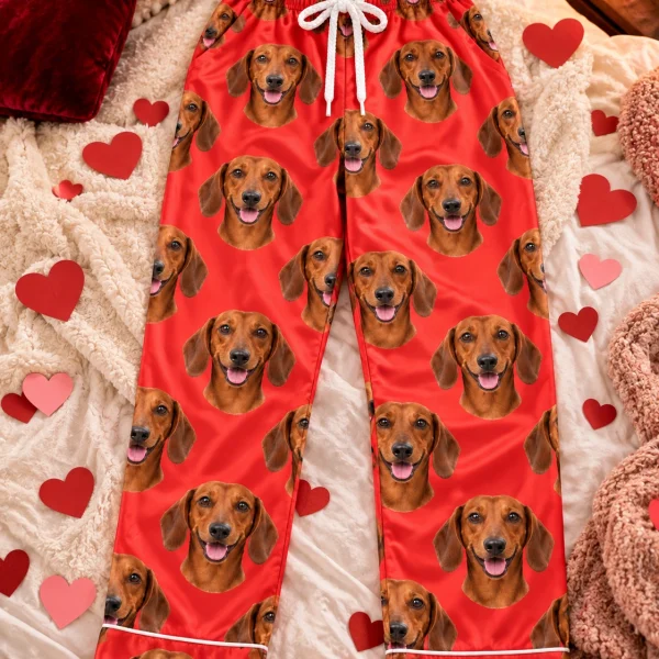 Flat lay of dachshund Valentine pajamas: pants covered in red smooth-coated Dachshund faces — MyDogPics