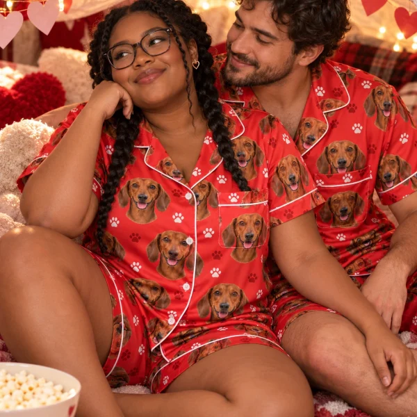 Woman and her partner in matching dachshund Valentines day pajama set with red smooth-coated Dachshund faces — MyDogPics