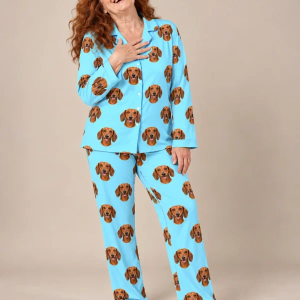 Woman wearing doxie pajamas covered in red smooth-coated Dachshund faces on light blue fabric — MyDogPics