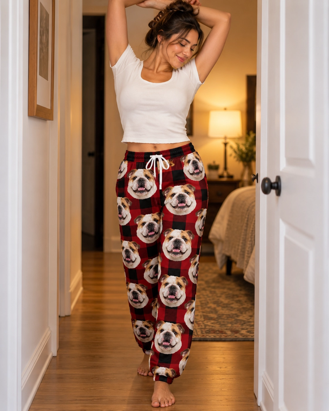 English Bulldog Christmas Pajama Pants – Front View, Red Plaid | MyDogPics Woman wearing english bulldog Christmas pajama pants covered in white-and-fawn English Bulldog faces — MyDogPics