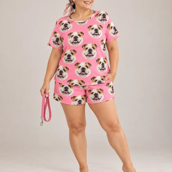 Woman wearing an english bulldog lounge set covered in white-and-fawn English Bulldog faces on pink fabric — MyDogPics