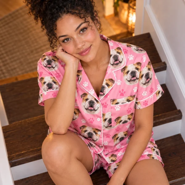 Woman sitting in an english bulldog pajama short set covered in white-and-fawn English Bulldog faces — MyDogPics