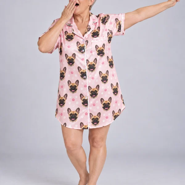 Woman posing in a French bulldog nightgown, fawn French Bulldog faces on blush pink paw-print satin — MyDogPics
