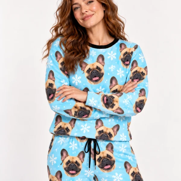 Woman wearing French bulldog winter pajamas covered in fawn French Bulldog faces on light blue snowflake fabric — MyDogPics