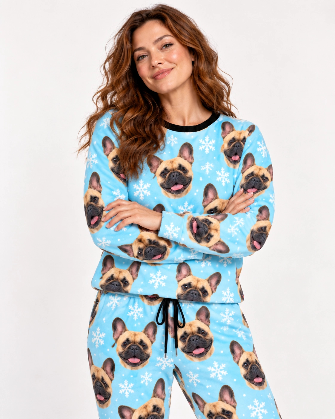 French Bulldog Winter Pajamas – Front View, Light Blue Snowflake | MyDogPics Woman wearing French bulldog winter pajamas covered in fawn French Bulldog faces on light blue snowflake fabric — MyDogPics