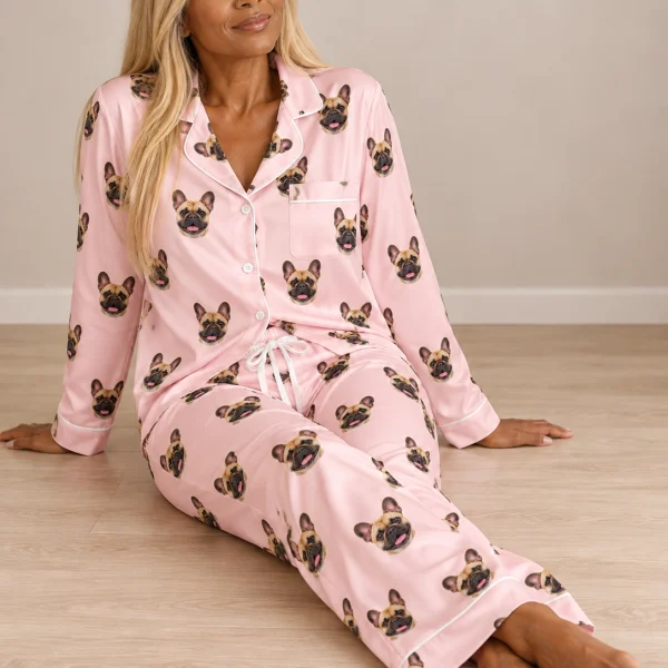 Woman sitting in a frenchie pajamas for women covered in fawn French Bulldog faces — MyDogPics