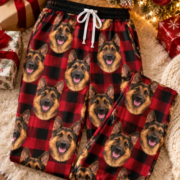 Flat lay of German shepherd Christmas pajama pants: pants covered in black-and-tan German Shepherd faces — MyDogPics