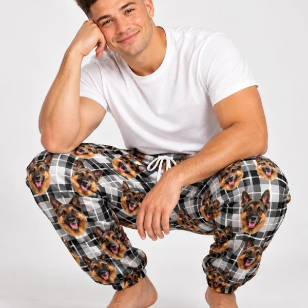 Man sitting in German shepherd pajama pants covered in black-and-tan German Shepherd faces — MyDogPics