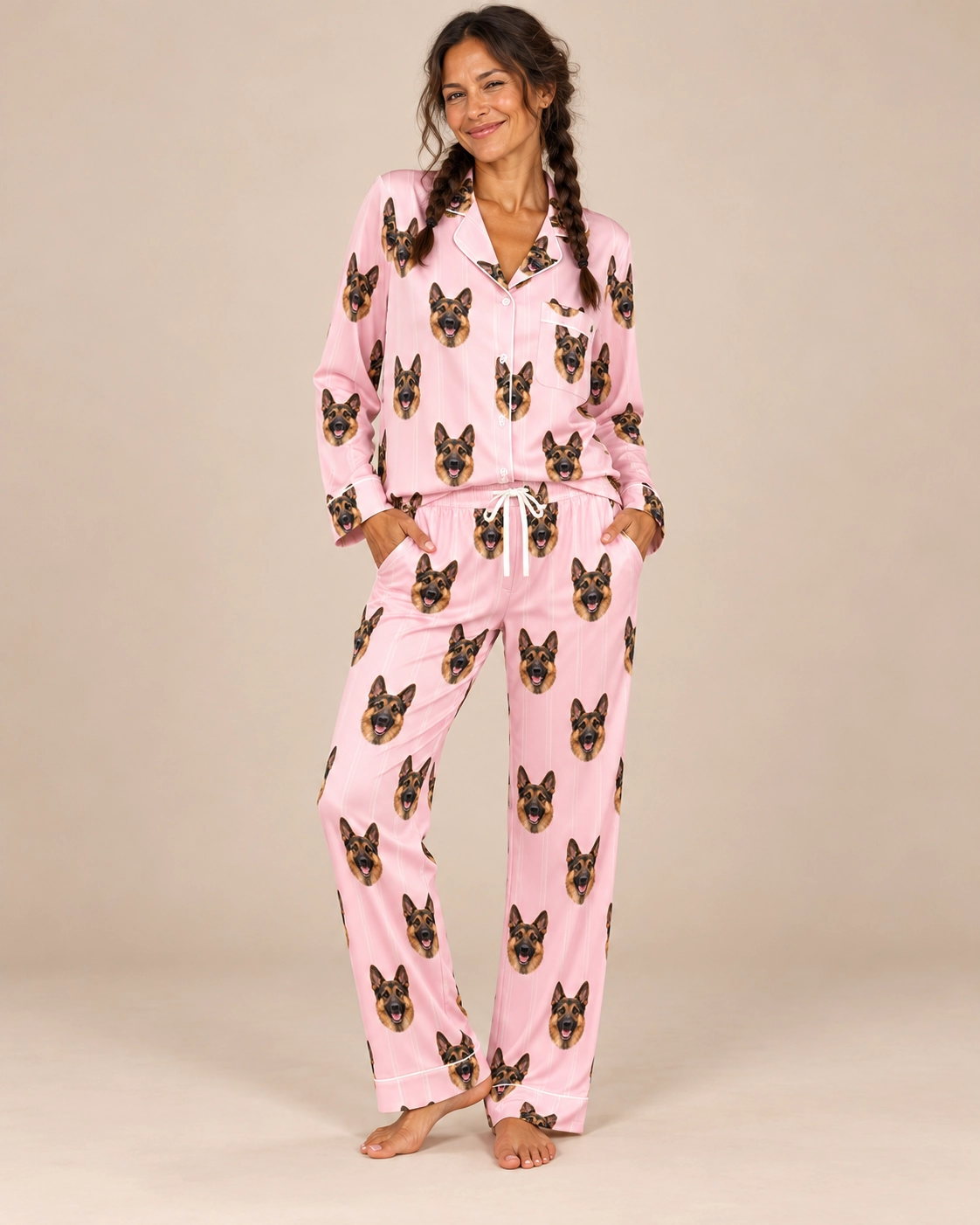 German Shepherd Pajamas for Women – Sitting, Blush Pink | MyDogPics Woman sitting in a German shepherd pajamas for women covered in black-and-tan German Shepherd faces — MyDogPics