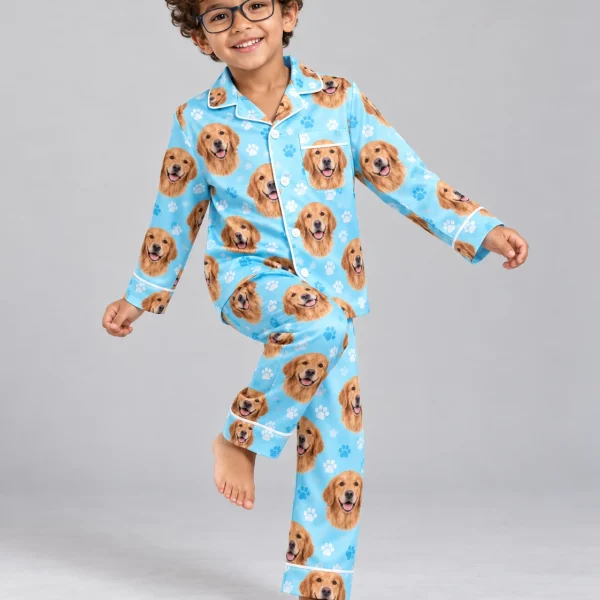 Boy posing in golden retriever kids pajamas, golden Golden Retriever faces on light blue paw-print satin — MyDogPics