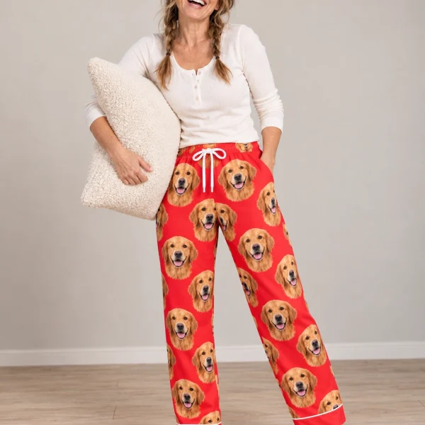Woman wearing golden retriever Valentine pajamas covered in golden Golden Retriever faces on red satin — MyDogPics