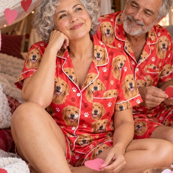 Woman and her partner in matching golden retriever Valentines day pajama set with golden Golden Retriever faces — MyDogPics