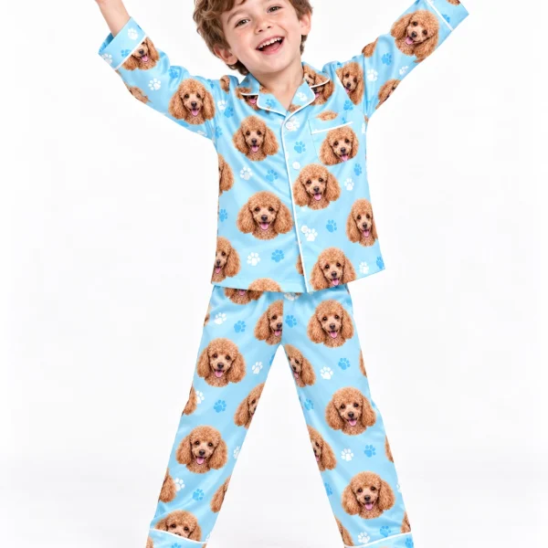 Boy wearing kids poodle pajamas covered in apricot Poodle faces on light blue paw-print satin — MyDogPics