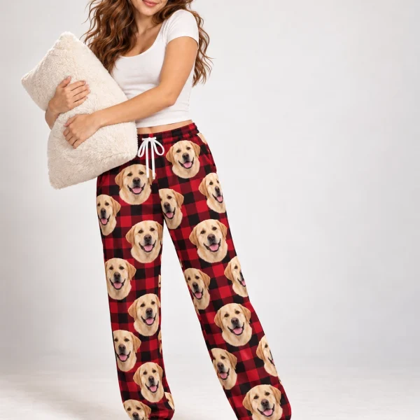 Woman posing in labrador Christmas pajama pants, yellow Labrador Retriever faces on red plaid fabric — MyDogPics