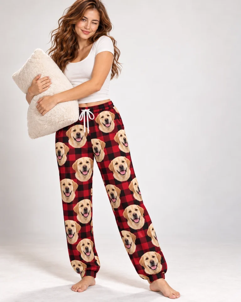 Woman posing in labrador Christmas pajama pants, yellow Labrador Retriever faces on red plaid fabric — MyDogPics