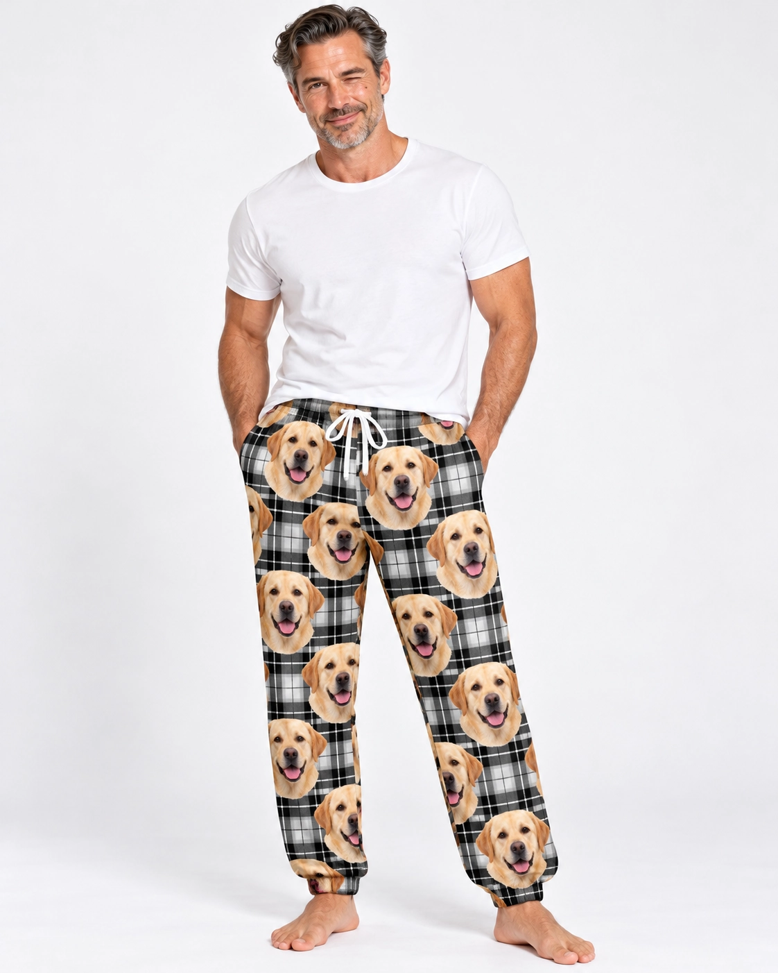 Labrador Pajama Pants – Front View, White Plaid | MyDogPics Man wearing labrador pajama pants covered in yellow Labrador Retriever faces on white plaid fabric — MyDogPics