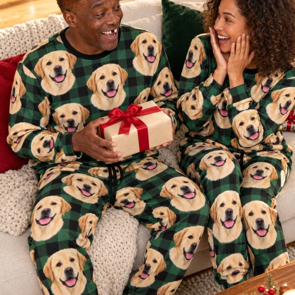 Man and his partner in matching labrador pajama set with yellow Labrador Retriever faces on green plaid fabric — MyDogPics