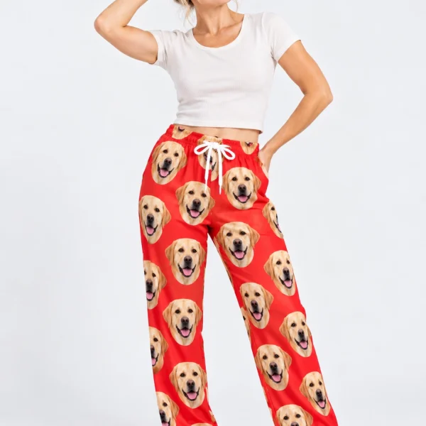 Woman posing in labrador Valentine pajamas, yellow Labrador Retriever faces on red satin — MyDogPics