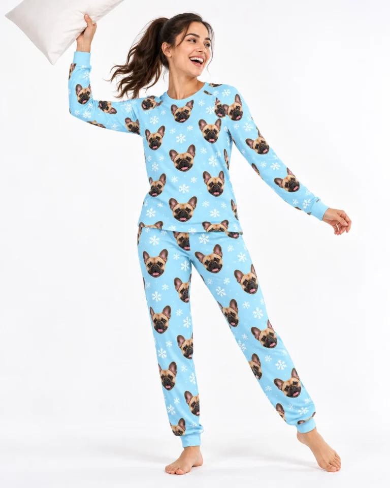 Woman posing in matching French bulldog pajamas, fawn French Bulldog faces on light blue snowflake fabric — MyDogPics