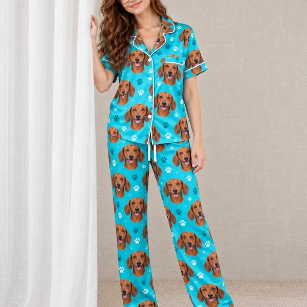 Woman wearing a pajamas with dachshunds covered in red smooth-coated Dachshund faces on teal paw-print satin — MyDogPics