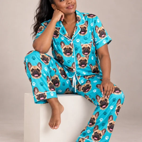 Woman sitting in a pajamas with French bulldogs covered in fawn French Bulldog faces — MyDogPics
