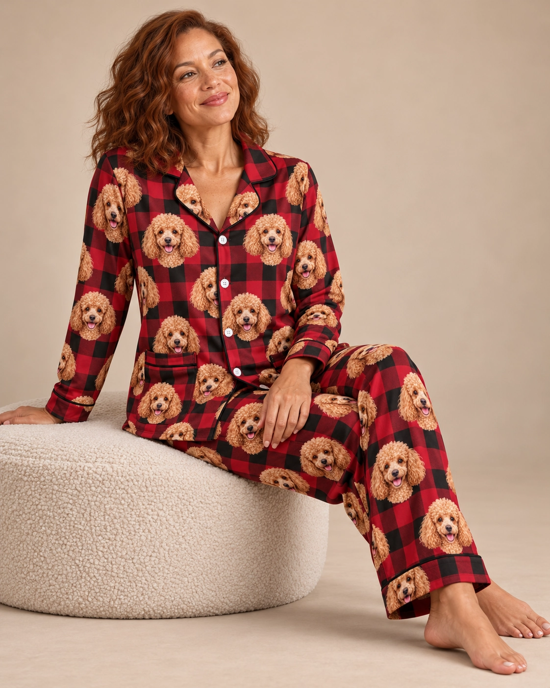 Poodle Christmas Pajamas – Sitting, Red Plaid | MyDogPics Woman sitting in poodle Christmas pajamas covered in apricot Poodle faces — MyDogPics
