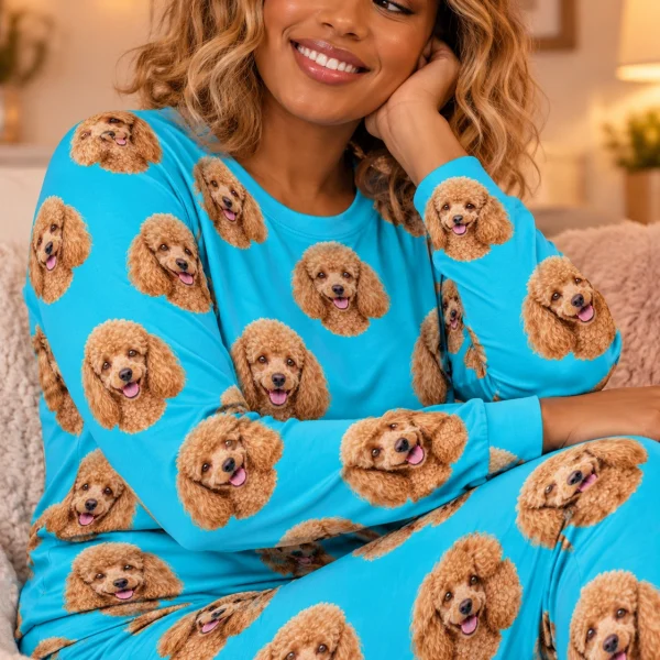 Woman sitting in a poodle pajamas for adults covered in apricot Poodle faces — MyDogPics
