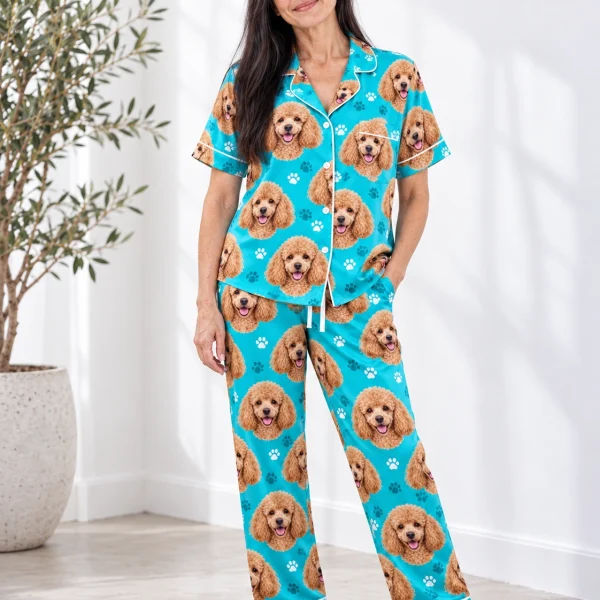 Woman wearing poodle print pajamas covered in apricot Poodle faces on teal paw-print satin — MyDogPics