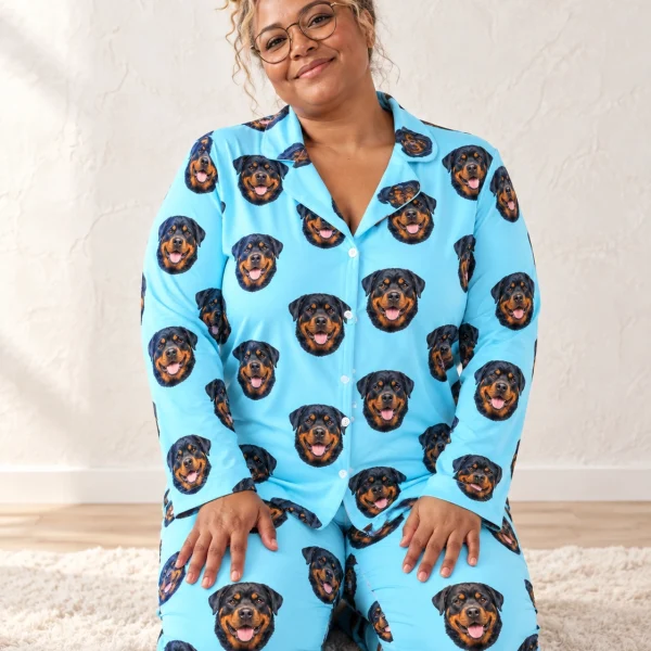 Woman sitting in rottie pajamas covered in black-and-mahogany Rottweiler faces — MyDogPics