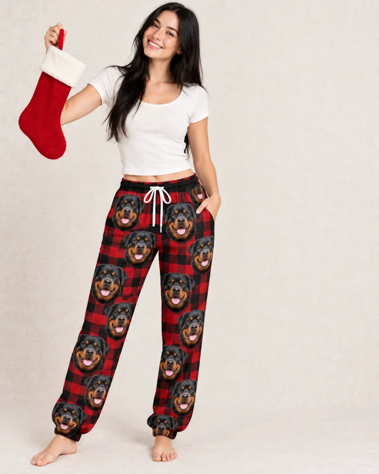 Woman wearing rottweiler Christmas pajama pants covered in black-and-mahogany Rottweiler faces — MyDogPics