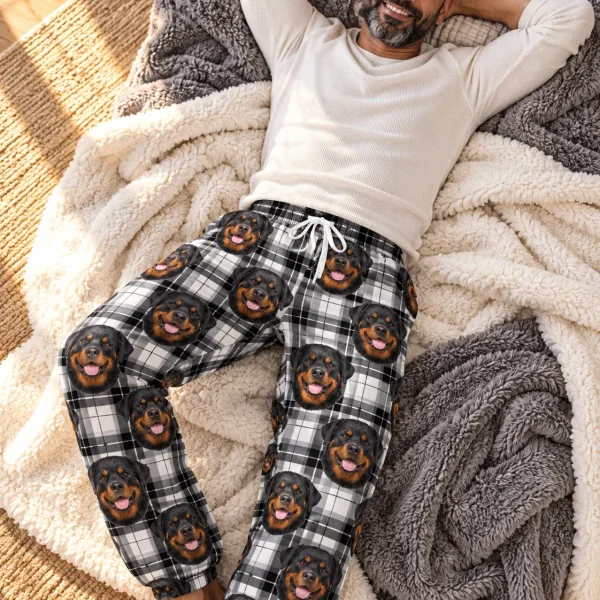 Man posing in rottweiler pajama pants, black-and-mahogany Rottweiler faces on white plaid fabric — MyDogPics
